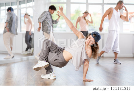 Girl poses against background of hip hop dancing people. Girl poses against background of hip hop dancing people. 131181515