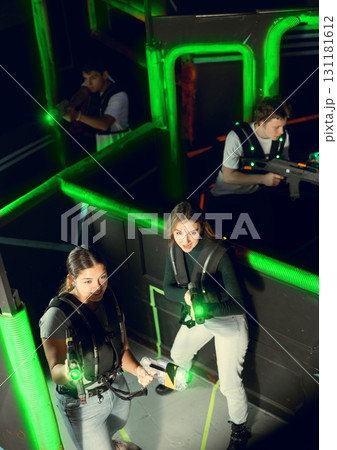 Team of young people play laser tag in labyrinth. View from above 131181612