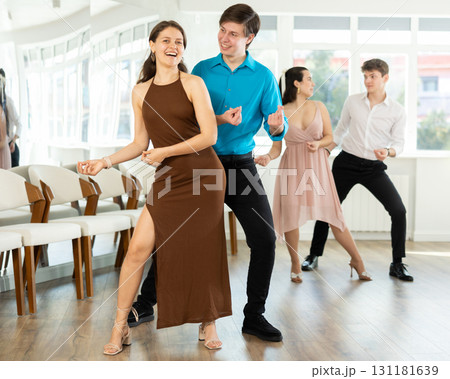 Couple young woman and man dancing twist 131181639
