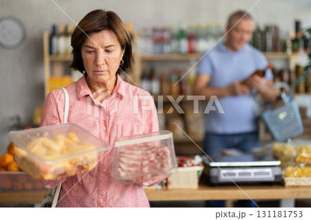 Elderly woman choosing chicken and pork in grocery store Elderly woman choosing chicken and pork in grocery store 131181753
