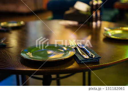 Restaurant plates dining: Table set for dinner with plates and silverware in upscale restaurant tonight. 131182061