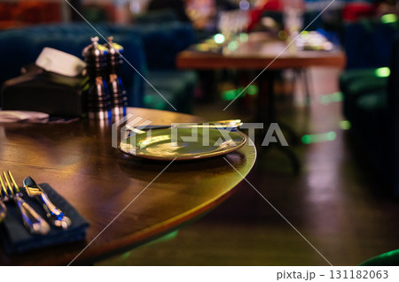 Restaurant Dining Table, Utensils. Restaurant table set for dining at night for enjoyment and relaxation. Restaurant Dining Table, Utensils. Restaurant table set for dining at night for enjoyment and relaxation. 131182063