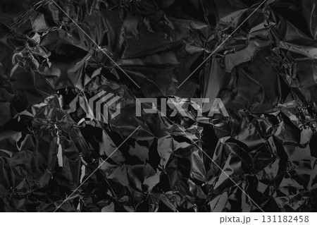 Shiny black grey foil metal texture, abstract wrapping paper for background and design art work. Shiny black grey foil metal texture, abstract wrapping paper for background and design art work. 131182458