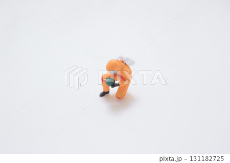 A Tiny Orange Astronaut Figure Walking Across A Tiny Orange Astronaut Figure Walking Across 131182725