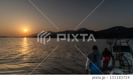 silhouette of couple on boat on the sea silhouette of couple on boat on the sea 131183724