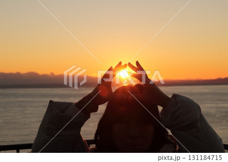 駿河湾の海の夕陽と一人旅女性のシルエット 131184715