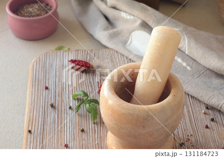 Marble mortar in kitchen. Food and cooking. Healthy eating and organic products. Marble mortar in kitchen. Food and cooking. Healthy eating and organic products. 131184723