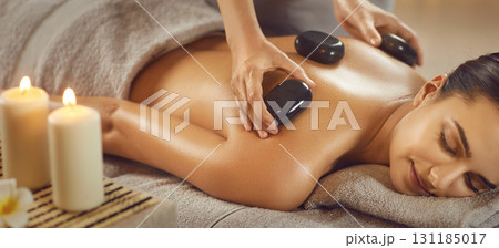 Relaxed young woman enjoying body treatment at wellness center Relaxed young woman enjoying body treatment at wellness center 131185017