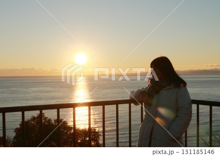 駿河湾の海の夕陽と一人旅女性のシルエット 131185146