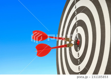 Red darts hit a target board with clarity and sharp precision Red darts hit a target board with clarity and sharp precision 131185853