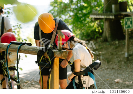 Child getting safety instructions in climbing park with instructor. outdoor activity Child getting safety instructions in climbing park with instructor. outdoor activity 131186600