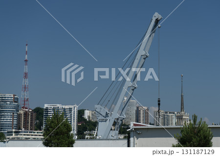 A tall metal crane for launching boats into the water. A tall metal crane for launching boats into the water. 131187129