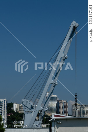 A tall metal crane for launching boats into the water. 131187161