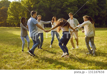 Group of cheerful and carefree best friends in park are circling together holding hands. Group of cheerful and carefree best friends in park are circling together holding hands. 131187638