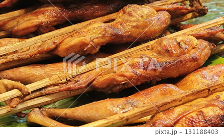 Thai grilled chicken on a rotisserie. Thai grilled chicken on a rotisserie. 131188403