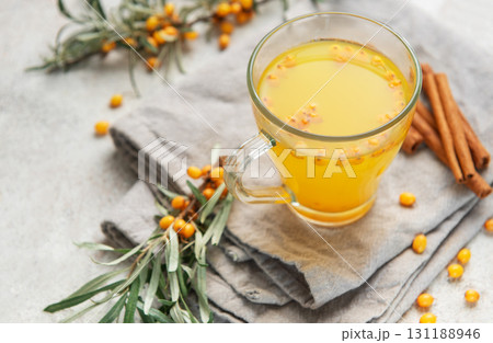 Sea buckthorn hot drink with cinnamon sticks and berries Sea buckthorn hot drink with cinnamon sticks and berries 131188946
