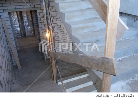 Staircase of multi-storey building under construction with brick walls. Staircase of multi-storey building under construction with brick walls. 131189128