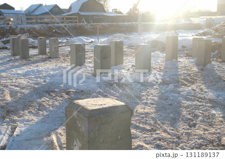 Building materials, piles, foundation on snow on construction site in city. Building materials, piles, foundation on snow on construction site in city. 131189137