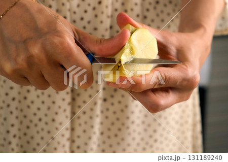 Woman peeling cutting apples cooking dish on kitchen at home, hands close-up. Woman peeling cutting apples cooking dish on kitchen at home, hands close-up. 131189240