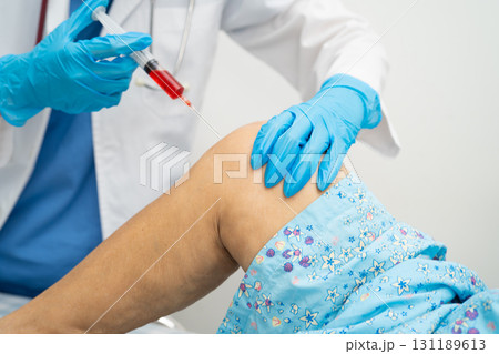 Asian doctor inject Hyaluronic acid platelet rich plasma into knee of senior woman. 131189613