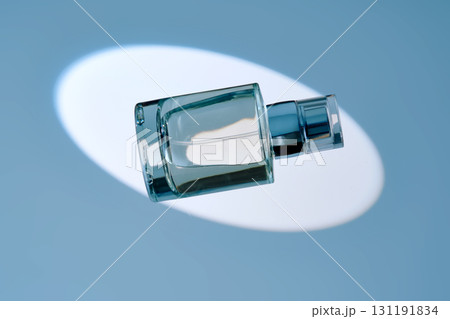 A spray bottle with hair mist or perfume on a blue background. 131191834