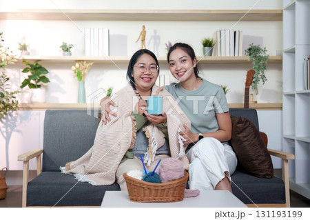 Bonding Moments: Two women enjoying tea and laughter at home Bonding Moments: Two women enjoying tea and laughter at home 131193199