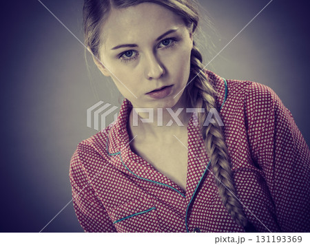 Sad young teenager woman sitting on bed Sad young teenager woman sitting on bed 131193369