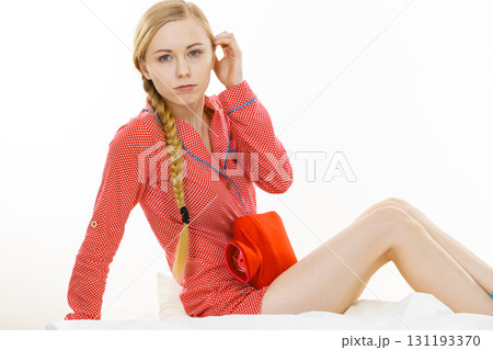 Woman feeling stomach cramps lying on bed 131193370