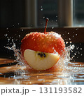 Red apple is sliced in half and is falling into a pool of water 131193582