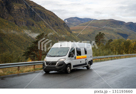 Camper van driving on mountain road in scenic landscape, Norway 131193660