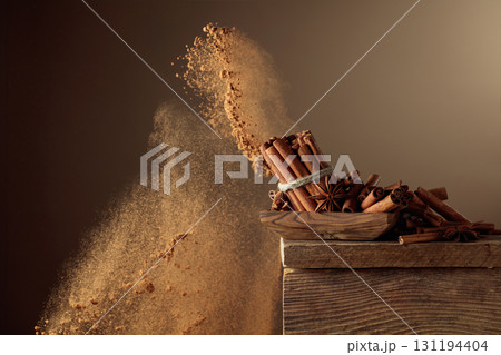 Cinnamon sticks and powder on a brown background. Cinnamon sticks and powder on a brown background. 131194404