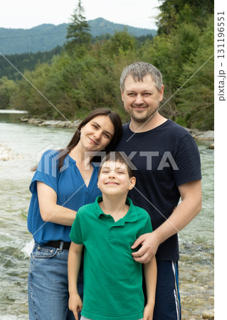 Happy Family with Mom Dad and Child Walking Together in Nature. 131196551
