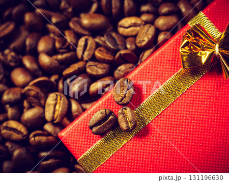 Red gift box on roasted coffee beans. Red gift box on roasted coffee beans. 131196630