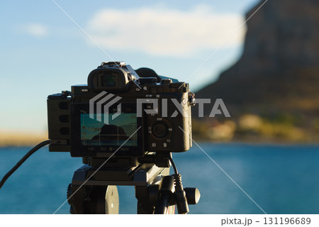 Camera on tripod and Monemvasia island Camera on tripod and Monemvasia island 131196689