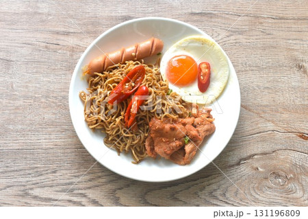 fried instant noodles in mala sichuan sauce topping egg and chicken on plate fried instant noodles in mala sichuan sauce topping egg and chicken on plate 131196809