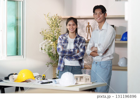 Engineer collaboration. Young engineers discussing architectural plans in a modern workspace. Engineer collaboration. Young engineers discussing architectural plans in a modern workspace. 131196896