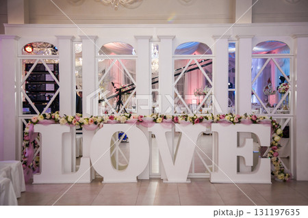 Creative love display at a wedding venue with elegant decor and floral arrangements Creative love display at a wedding venue with elegant decor and floral arrangements 131197635
