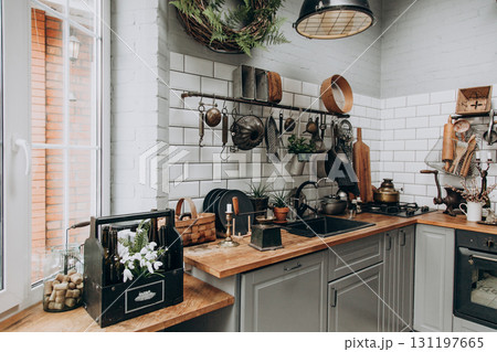 Cozy modern kitchen with rustic elements and natural light from the window Cozy modern kitchen with rustic elements and natural light from the window 131197665