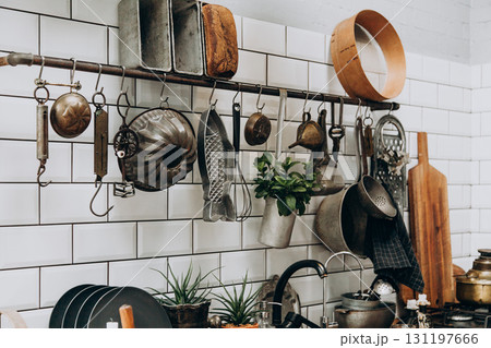 Kitchen with vintage utensils and rustic decor creating a cozy cooking atmosphere Kitchen with vintage utensils and rustic decor creating a cozy cooking atmosphere 131197666