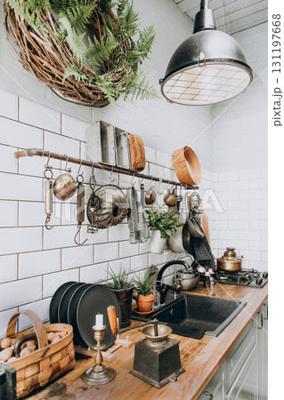 Cozy kitchen with vintage decor and greenery in a warm setting 131197668