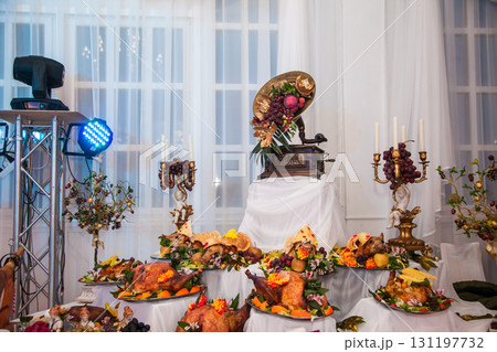 Stunning banquet display with festive dishes and decorations at a celebratory event Stunning banquet display with festive dishes and decorations at a celebratory event 131197732