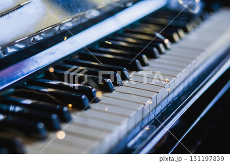 The keys of an old vintage piano in the background light with highlights. The keys of an old vintage piano in the background light with highlights. 131197839