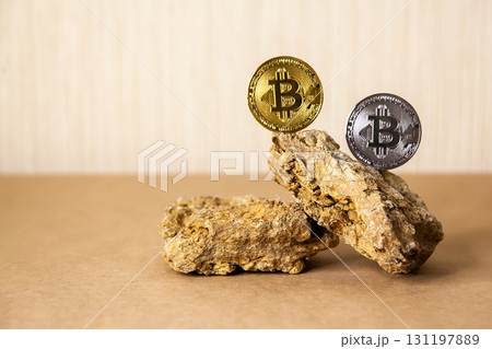 Gold and silver Bitcoin Coins balances on natural stones on light background. Blockchain cryptocurrency, store of value 131197889