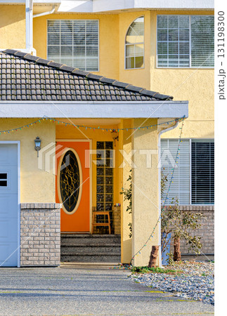 Orange door of residential house main entrance on bright sunny day Orange door of residential house main entrance on bright sunny day 131198300