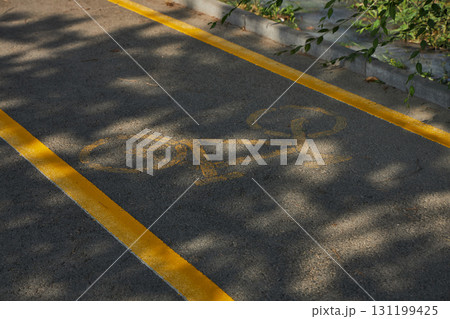 Bike lane, bicycle path with yellow markings.  131199425