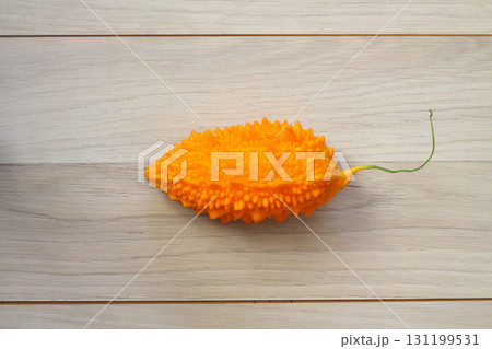 Momordica charantia isolated on a wooden background. Ripe whole fruits of Momordica charantia 131199531