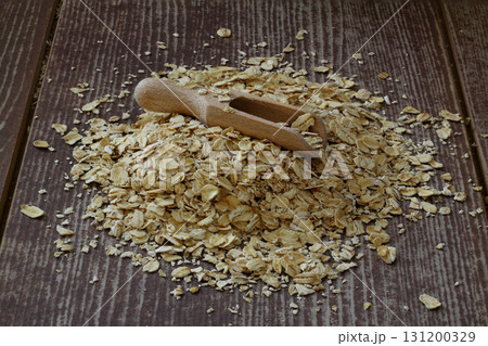 Oat flake in a sack and spoon on the wooden table Oat flake in a sack and spoon on the wooden table 131200329