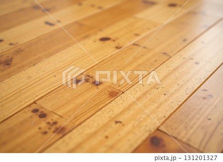 Sunlight filters through a window, revealing the warm tones and intricate grain patterns of a rustic wooden floor. The texture and color reflect the surrounding atmosphere of comfort Generative AI 131201327
