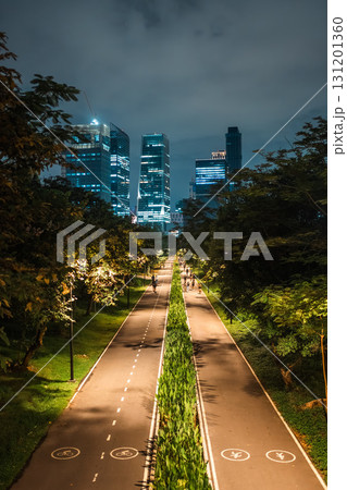 skyscrapers of night Bangkok city with Benchakitti park tracks, illuminated pathways and walkways with people walking and jogging, harmony of bustling city and nature skyscrapers of night Bangkok city with Benchakitti park tracks, illuminated pathways and walkways with people walking and jogging, harmony of bustling city and nature 131201360