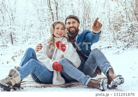 Happy young couple in the winter forest feeling excited and enjoyed 131201870